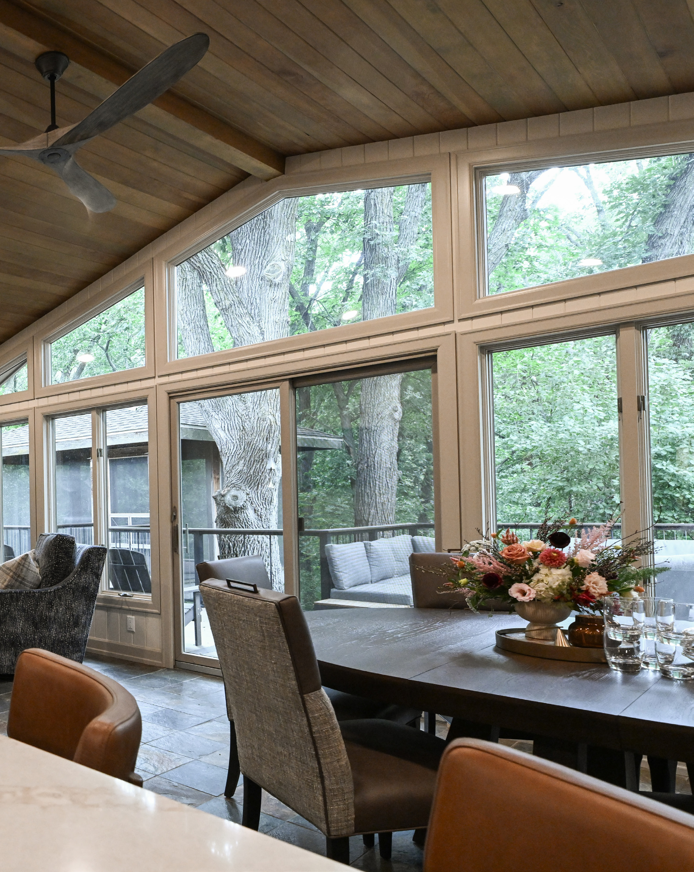 Window-lined dining area with a wood ceiling, shown in the Built With Pride feature.